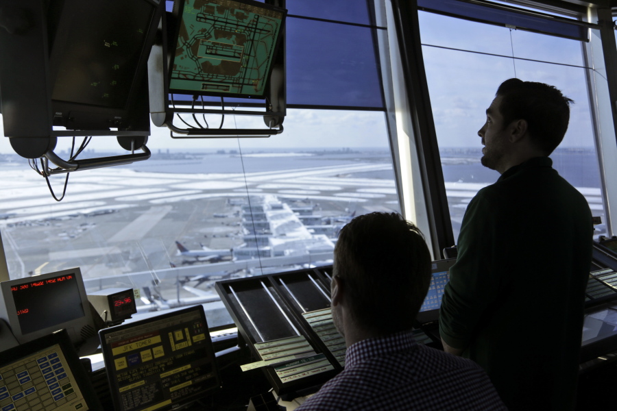 In this March 16, 2017 photo, air traffic controllers work in the tower at John F. Kennedy International Airport in New York. A House panel on Tuesday weighed legislation that would split off management of the nation’s skies from the Federal Aviation Administration and give that responsibility to an independent, nonprofit company.