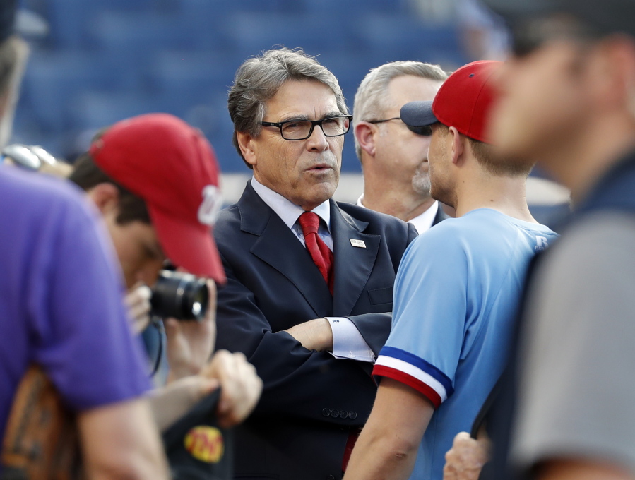 Energy Secretary Rick Perry stands on the field before the Congressional baseball game June 15 in Washington. The annual GOP-Democrats baseball game raises money for charity.
