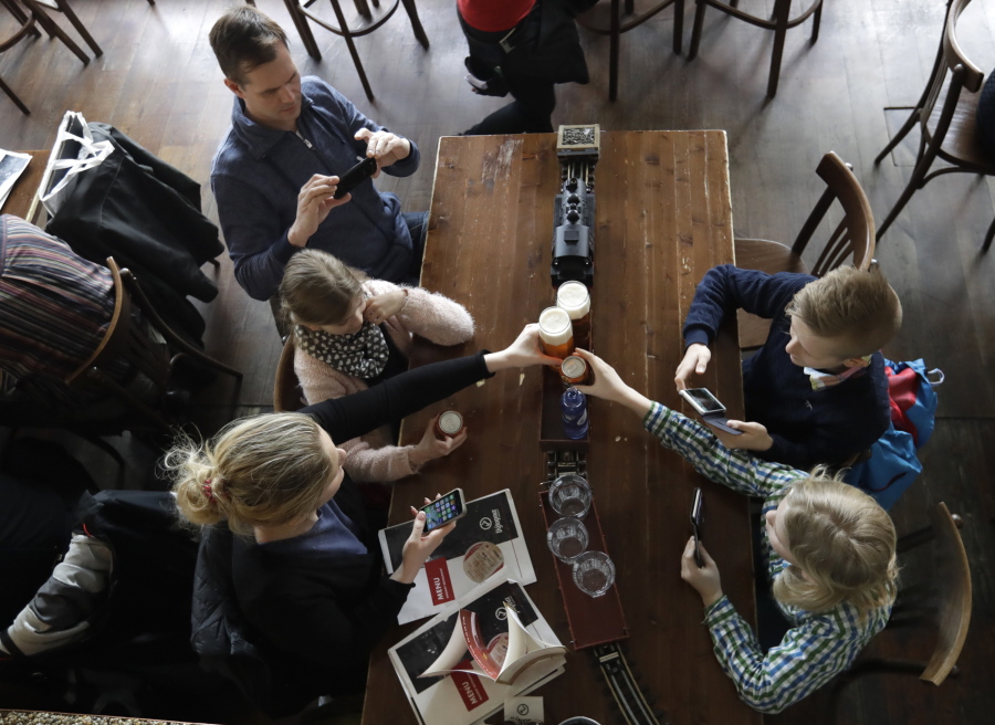 Costumers take drinks from a model freight train in a restaurant in Prague, Czech Republic, April 19. In three Czech restaurants, model freight trains arrive at your table and stop right in front of you with your order of drinks. The only thing you have to do is to pick up your glass before the train departs.