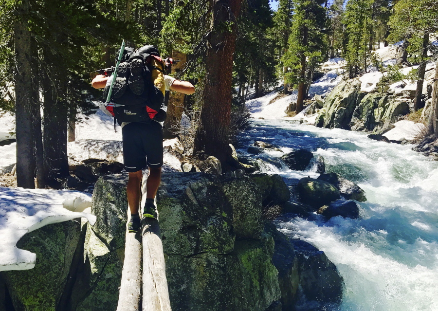 Jake Gustafson crosses Bear Creek along the Pacific Crest Trail near Kings Canyon National Park, Calif., on June 16. With hundreds of so-called thru-hikers entering the high Sierra early in the season, their experiences serve as a cautionary tale for others planning weekend or summer wilderness escapes.