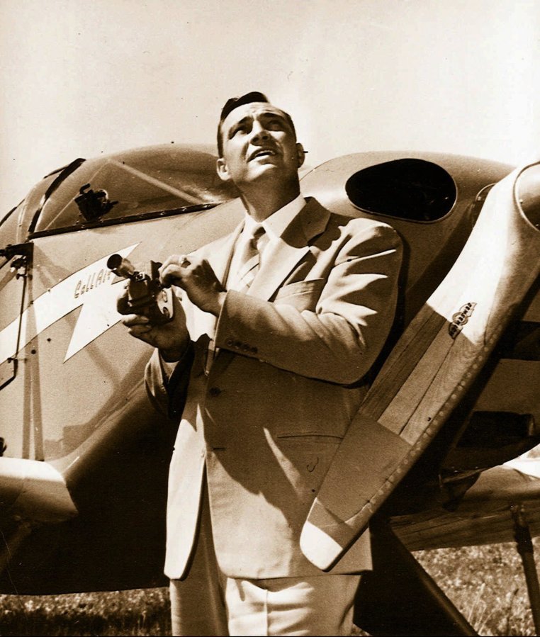 Kenneth Arnold holds a movie camera in front of his CallAir, after he reported seeing nine alleged UFOs near Mount Rainier in 1947.