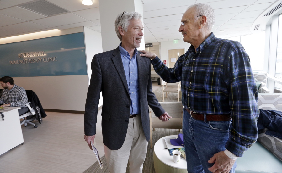 Dr. David Maloney of the Fred Hutchinson Cancer Research Center in Seattle is greeted by patient Ken Shefveland of Vancouver, whose lymphoma was successfully treated with CAR-T cell therapy. Immune therapy is the hottest trend in cancer care and its next frontier is creating “living drugs” that grow inside the body into an army that seeks and destroys tumors.