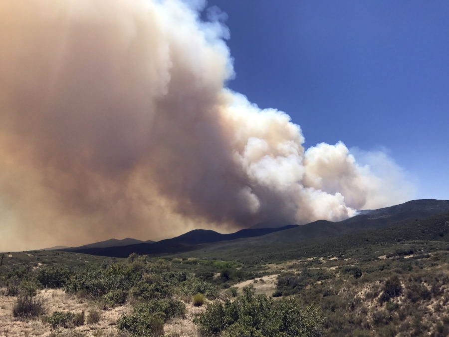 Smoke billows from a wildfire locally called Goodwin Fire, near Prescott, Ariz., on Tuesday. More than 500 firefighters braced for windy conditions Tuesday as they continued to battle the northern Arizona wildfire that has burned 6.8 square miles (17.6 sq. kilometers) so far.