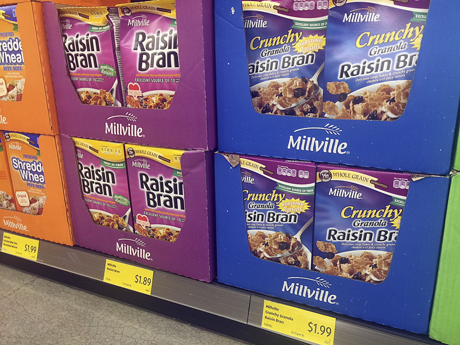 Boxes of the Aldi food market chain’s Millville Raisin Bran are on display in a purple box similar to the versions made by Kellogg and Post, at an Aldi store in New York. Stocking shelves with store brands is a big part of how discounters keep costs down.
