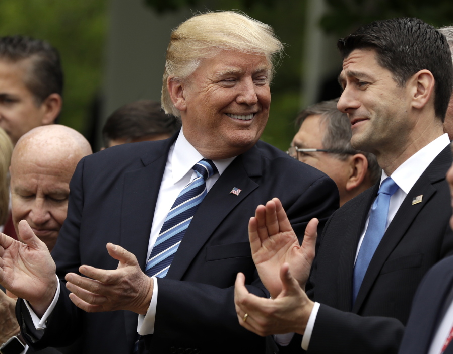 President Donald Trump talks to House Speaker Paul Ryan of Wis. in the Rose Garden of the White House in Washington, on May 4 after the House pushed through a health care bill. Trump promised to make health care more affordable but a government report finds that out-of-pocket costs — deductibles and copayments — would average 61 percent higher under the House Republican bill.