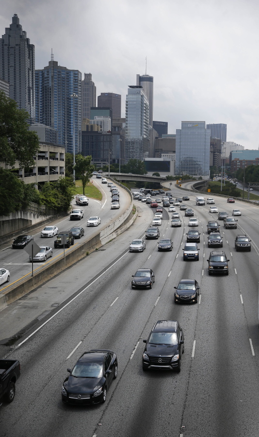 Traffic flows out of downtown Atlanta on the Interstate 75/85 Connector in May 2016. More people are expected to put down the TV remote and hit the road for the July 4 weekend. Auto club AAA predicts that 44.2 million people will travel over the holiday period, most of them by car, up 2.9 percent over a year earlier.