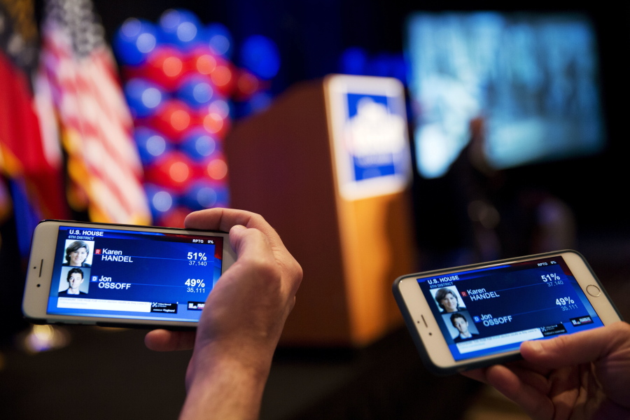 Supporters watch returns come in on their phones while attending the election night party of Democratic candidate for 6th congressional district Jon Ossoff in Atlanta on Tuesday.