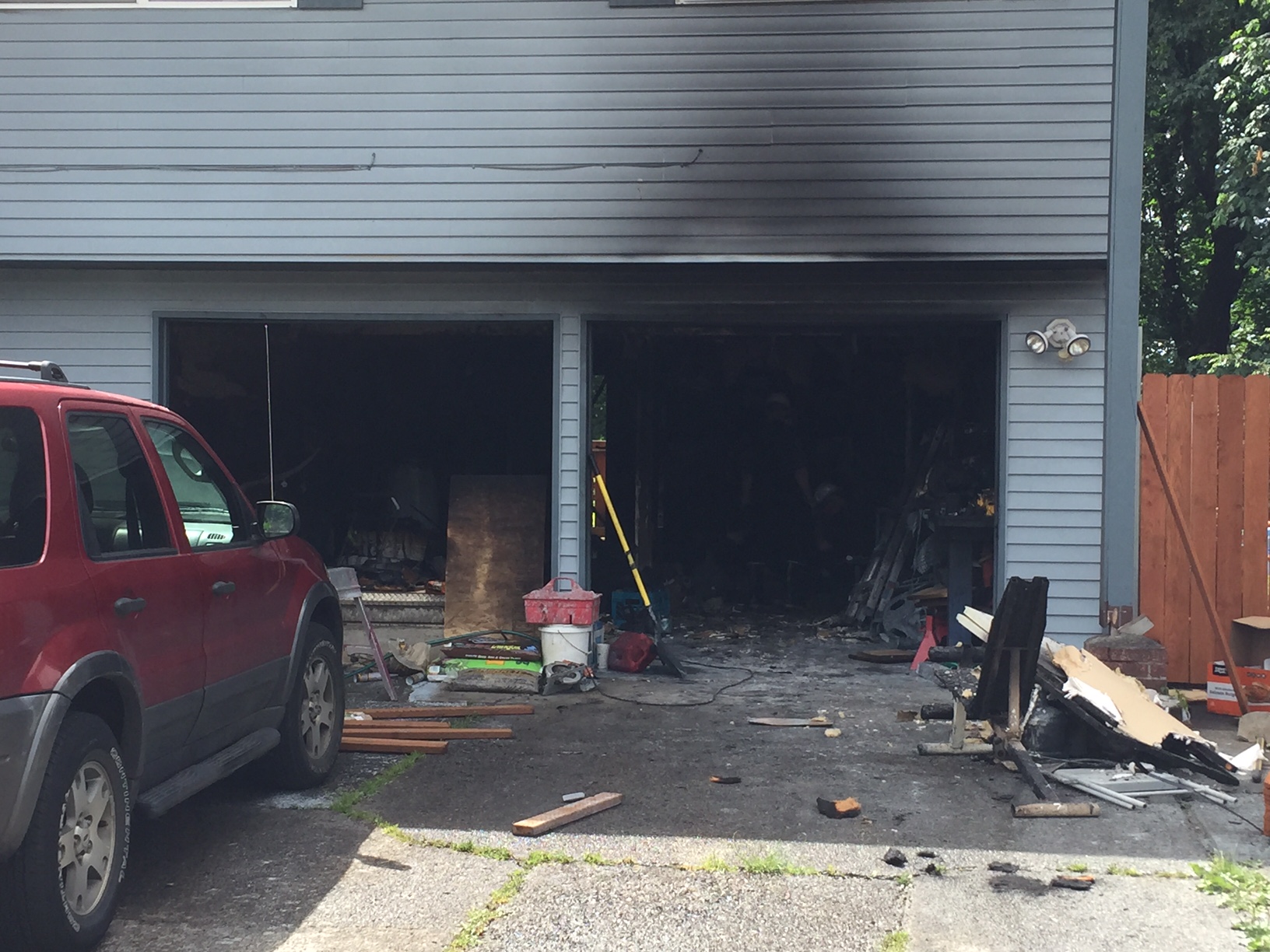 Vancouver firefighters brought a blaze in a garage under control in about 15 minutes. Three people were displaced as the house sustained smoke damage and power to the building had to be shut off because the electrical panel melted.