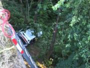 Firefighters worked for about a half an hour to reach an injured driver who went down an embankment and was ejected in a crash on Interstate 5 Thursday evening.