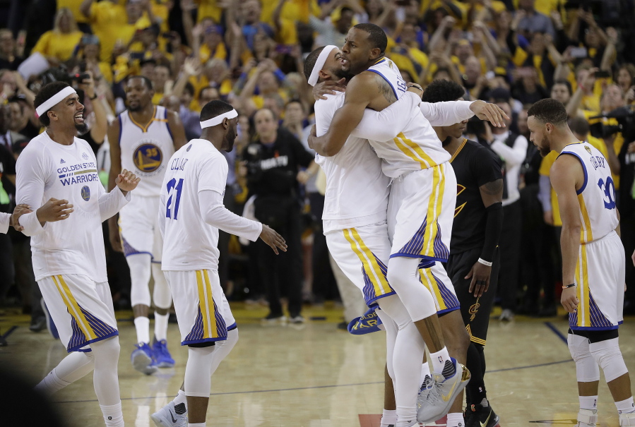 Golden State Warriors players celebrate after beating the Cleveland Cavaliers in Game 5 of basketball's NBA Finals in Oakland, Calif., Monday, June 12, 2017. The Warriors won 129-120 to win the NBA championship.