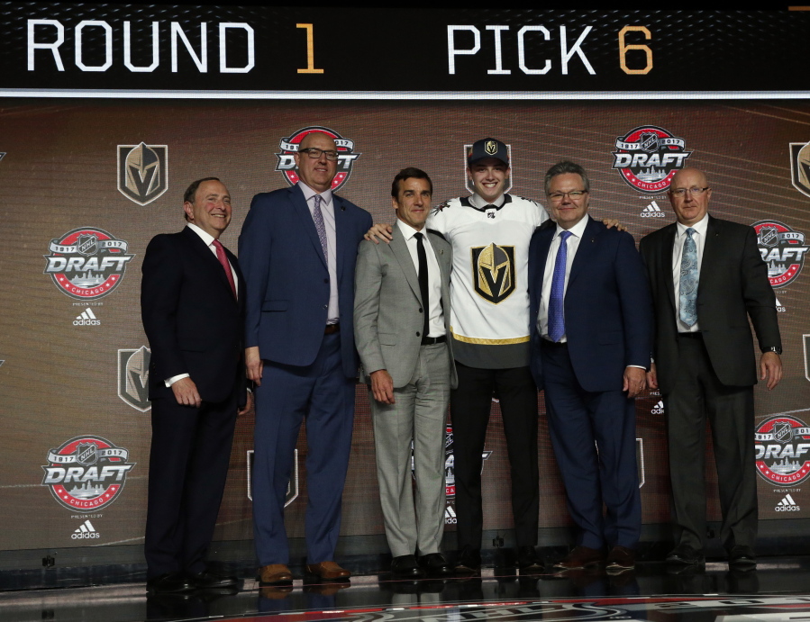 Cody Glass, third from right, wears a Vegas Golden Knights jersey after being selected by the team in the first round of the NHL hockey draft, Friday, June 23, 2017, in Chicago. (AP Photo/Nam Y.