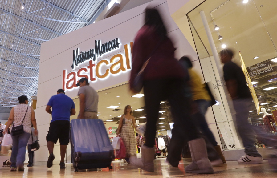 Shoppers walk by a Neiman Marcus Last Call department store in Miami.