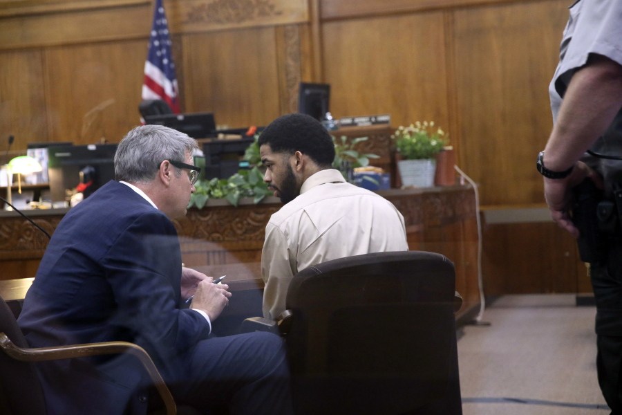 Former Milwaukee police officer Dominique Heaggan-Brown, center, speaks with his attorney Jonathan Smith in Milwaukee County Court on Wednesday in Milwaukee after being acquitted on first-degree reckless homicide charges in the killing of Sylville Smith.