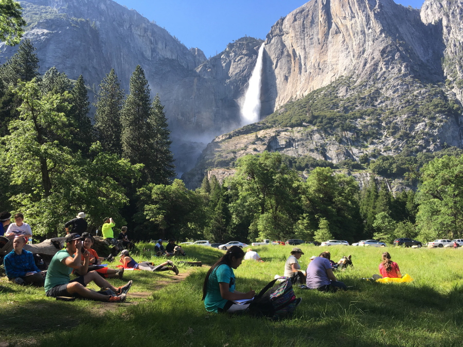 A class of eighth grade students and their chaperones sit in a meadow May 25 at Yosemite National Park, Calif., below Yosemite Falls. Officials fear a surge in drownings following record snowfall this winter as the weather heats up in California and other U.S. western states.