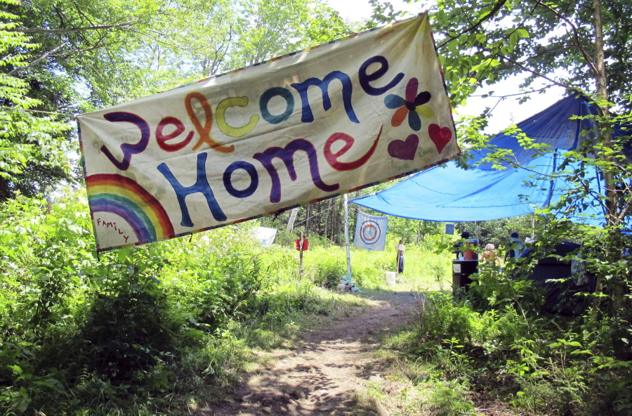 A sign welcomes people to the gathering of the Rainbow Family of Living Light in Mount Tabor, Vt., last year. Federal prosecutors and judges are setting up a temporary court in remote Eastern Oregon to handle citations against any attendees at the Rainbow Family of Living Light annual counter-culture gathering.