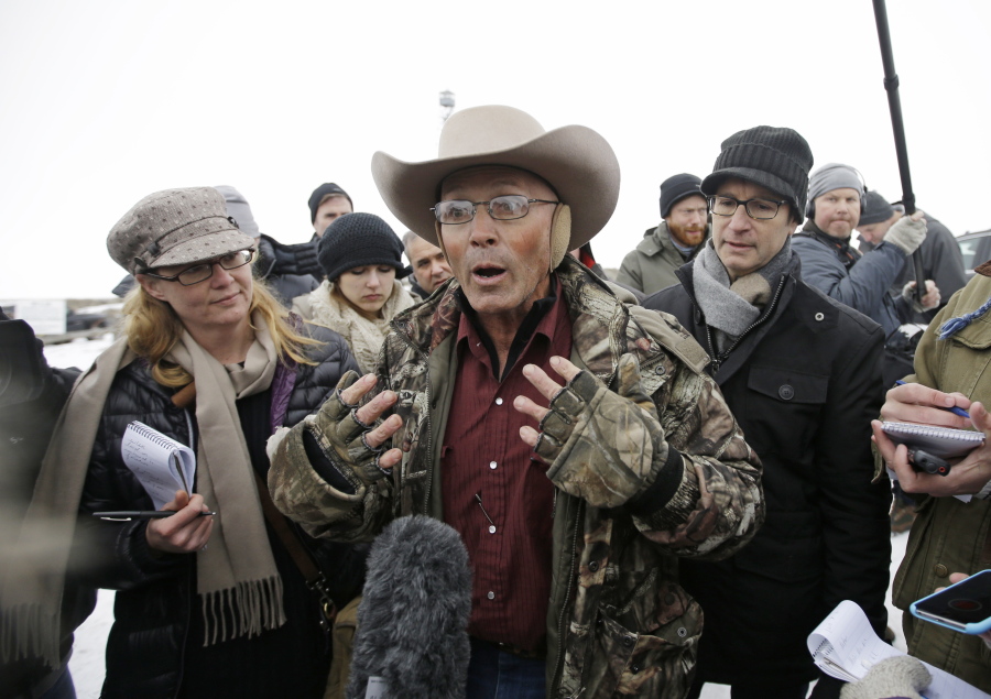 FILE - In this Jan. 5, 2016 file photo, Robert "LaVoy" Finicum, center, a rancher from Arizona, talks to reporters at the Malheur National Wildlife Refuge near Burns, Ore. An FBI agent has been indicted on accusations that he lied about firing at Finicum in 2016 when officers arrested leaders of an armed occupation of a federal wildlife refuge in rural Oregon. Sources familiar with the case say the agent will face allegations of making a false statement with intent to obstruct justice, The Oregonian/OregonLive reported Tuesday, June 27, 2017.