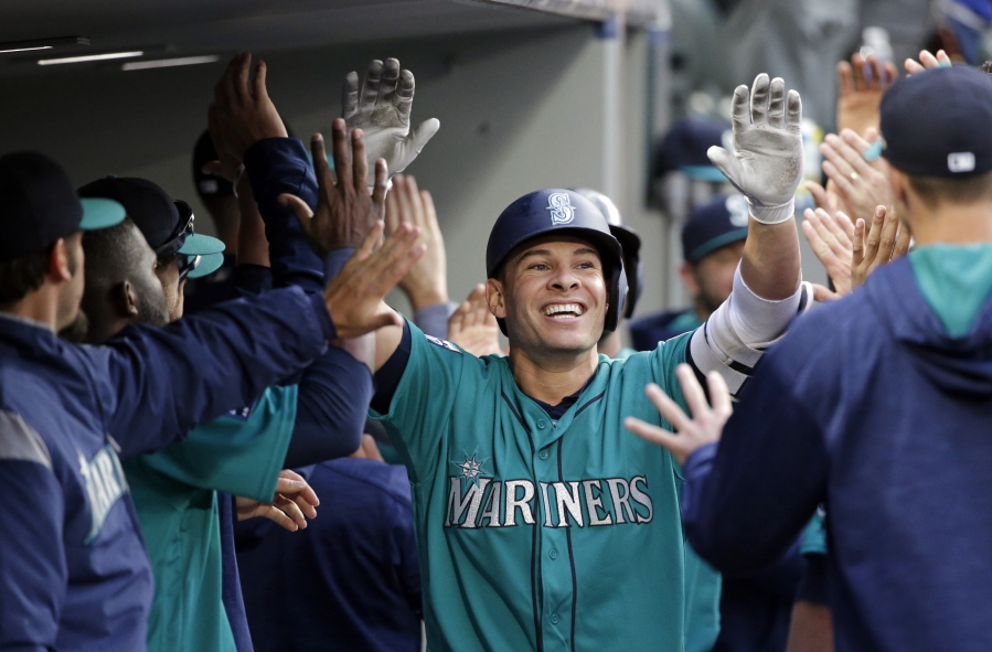 Seattle Mariners' Danny Valencia is congratulated by teammates on his three-run home run against the Tampa Bay Rays during the third inning of a baseball game Friday, June 2, 2017, in Seattle.