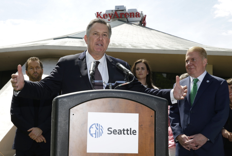 Tim Leiweke, center, CEO of the Oak View Group speaks during a news conference as Seattle Mayor Ed Murray looks on at right, Wednesday, June 7, 2017, in front of KeyArena in Seattle. Murray said the city will enter into negotiations with the Oak View Group on a proposal for a privately-financed renovation of the city-owned KeyArena. Plans for the remodel would bring the building up to standards that could attract an NHL or NBA franchise once completed. (AP Photo/Ted S.