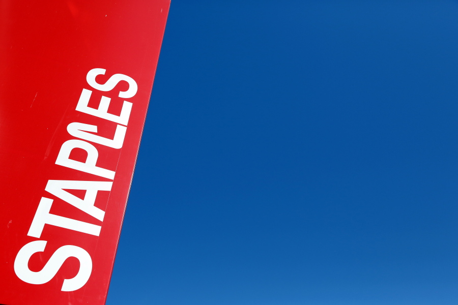 FILE - This Tuesday, March 1, 2016, file photo, shows a Staples store sign in New York. On Wednesday, June 28, 2017, private equity firm Sycamore announced it is buying office supplies chain Staples for $6.9 billion.