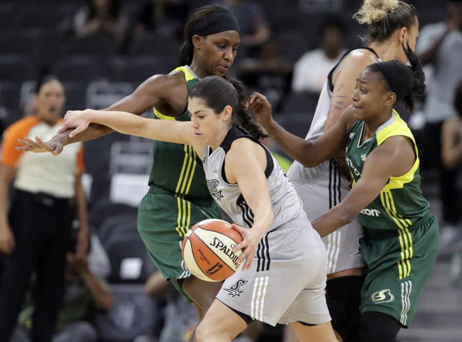 San Antonio Stars guard Kelsey Plum drives with the ball during the second half of a WNBA basketball game against the Seattle Storm in San Antonio. Plum returns to her college hometown of Seattle this weekend when San Antonio faces Seattle on Sunday. It's a return to the city where Plum developed into the NCAA all-time record holder in scoring at Washington and it will be Plum's first trip back to Seattle since being drafted No. 1 overall by the Stars.
