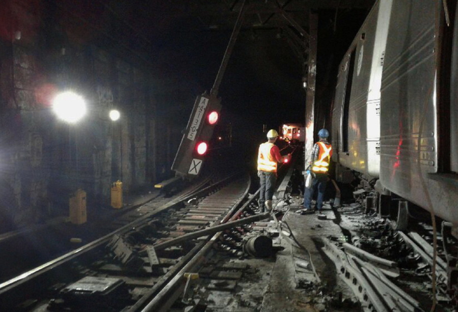 In this photo provided by the Transport Workers Union, Local 100, workers from the New York Metropolitan Transportation Authority respond to the scene of a subway derailment, Tuesday, June 27, 2017, in New York. A subway train derailed near a station in the Harlem neighborhood of New York, frightening passengers and resulting in minor injuries as hundreds of people were evacuated from trains along the subway line.