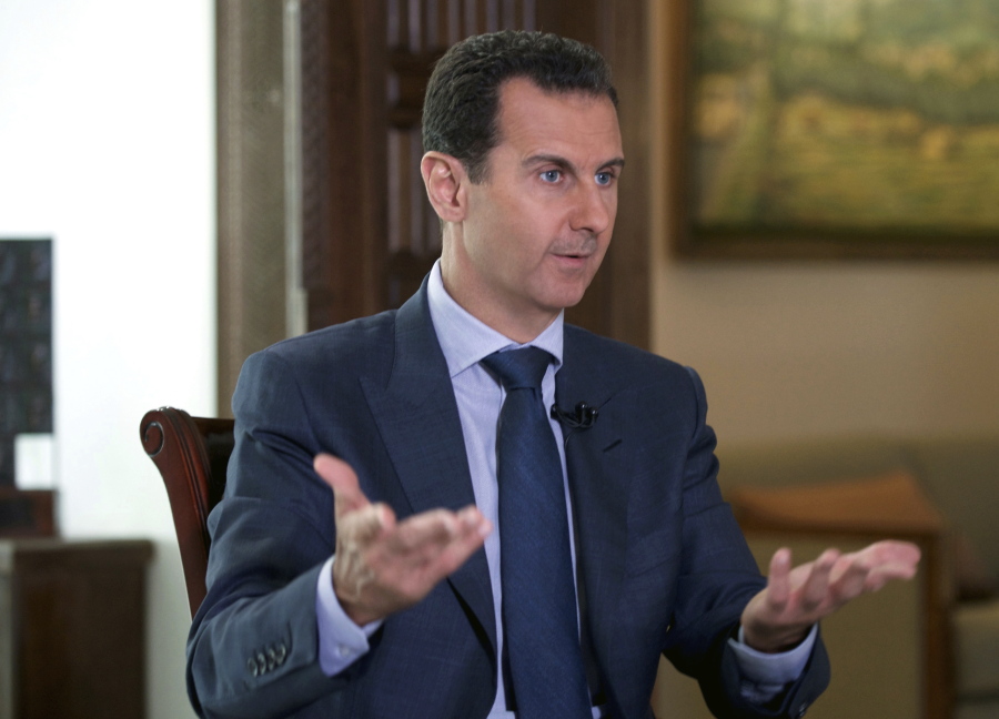 Syrian President Bashar Assad speaks to The Associated Press at the presidential palace in Damascus, Syria.