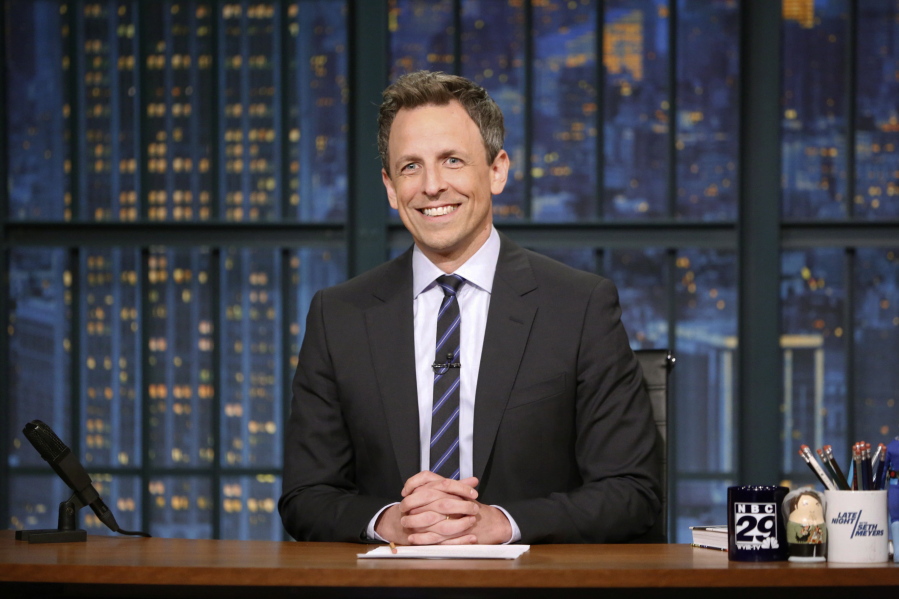 Seth Meyers sits at his desk May 3 during a taping of “Late Night with Seth Meyers” in New York.