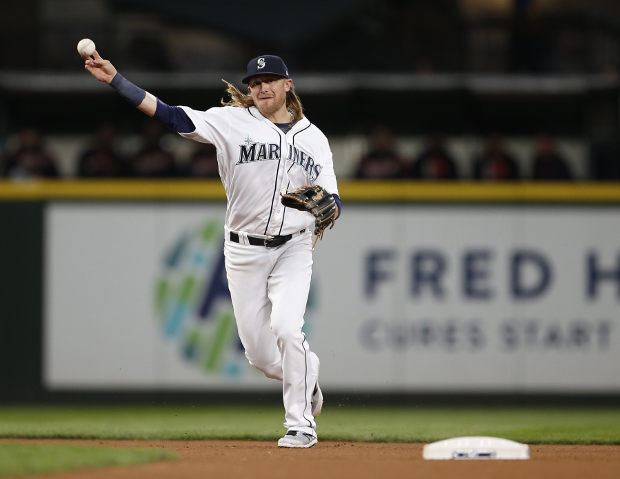 Seattle Mariners shortstop Taylor Motter throws out Detroit Tigers' James McCann at first base during the fourth inning of a baseball game Tuesday, June 20, 2017, in Seattle.