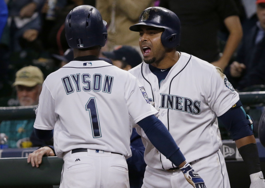 Seattle Mariners' Nelson Cruz, right celebrates with Jarrod Dyson (1) after Dyson scored during the sixth inning of a baseball game against the Detroit Tigers, Wednesday, June 21, 2017, in Seattle. (AP Photo/Ted S.