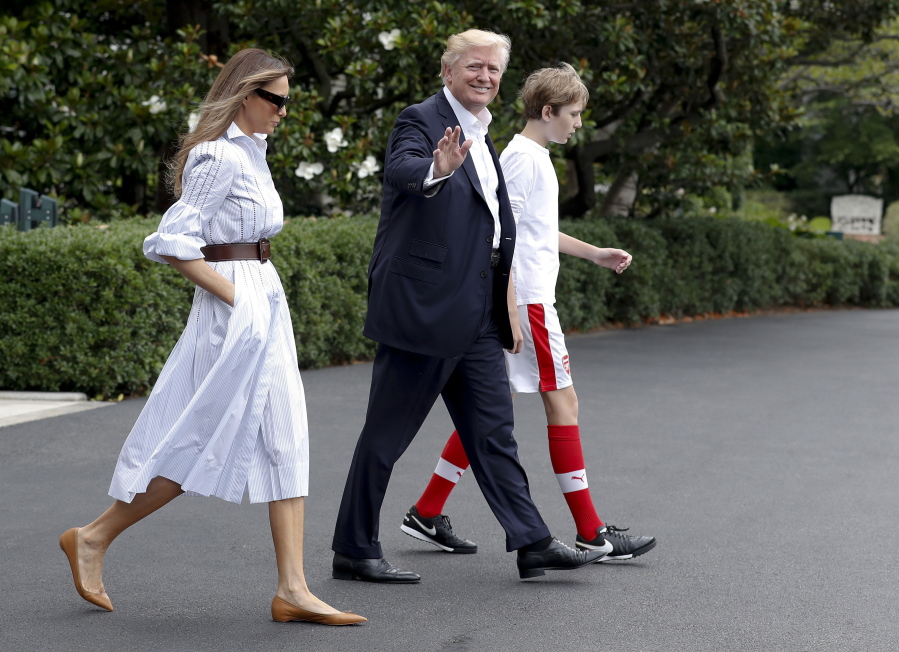 President Donald Trump, first lady Melania Trump, and their son and Barron Trump, walk to Marine One across the South Lawn of the White House in Washington, Saturday, June 17, 2017, en route to Camp David in Maryland.