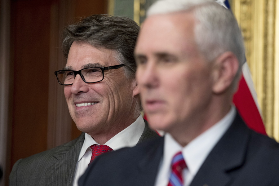 Vice President Mike Pence, right, speaks before administering the oath of office to Energy Secretary Rick Perry, left, in the Eisenhower Executive Office Building on the White House complex in Washington. Perry said Monday that the Trump administration is confident officials can “pave the path toward U.S. energy dominance” by exporting oil, gas and coal to markets around the world, and promoting nuclear energy and even renewables such as wind and solar power.