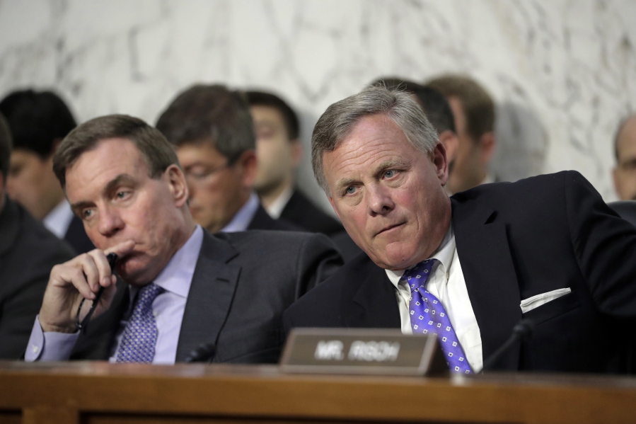 Sen. Richard Burr, R-N.C., right, chairman of the Senate Select Committee on Intelligence, and Vice Chairman Mark Warner, D-Va., left, listen as Attorney General Jeff Sessions testifies before the Senate Select Committee on Intelligence about his role in the firing of FBI Director James Comey and the investigation into contacts between Trump campaign associates and Russia, on Capitol Hill in Washington, Tuesday, June 13, 2017. (AP Photo/J.