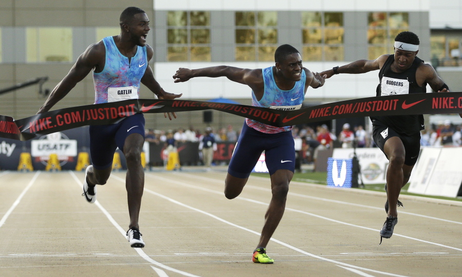 Justin Gatlin, left, reacts as he defeats Christian Coleman, center, in the men’s 100-meter final at the U.S. Track and Field Championships at Sacramento on Friday.