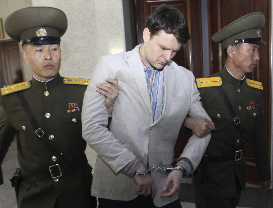 Otto Warmbier, center, is escorted at the Supreme Court in Pyongyang, North Korea, on March 16, 2016.