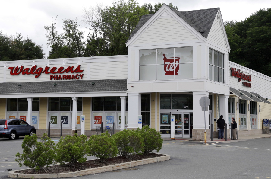 FILE - This Tuesday, July 5, 2016, file photo shows a Walgreens drugstore in North Andover, Mass. Walgreens ended its takeover pursuit of rival Rite Aid following resistance from U.S. regulators and will instead now buy stores, distribution centers and inventory in a new deal.