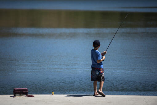Logan Lewi, 10, of Vancouver fishes at Klineline Pond in Salmon Creek.