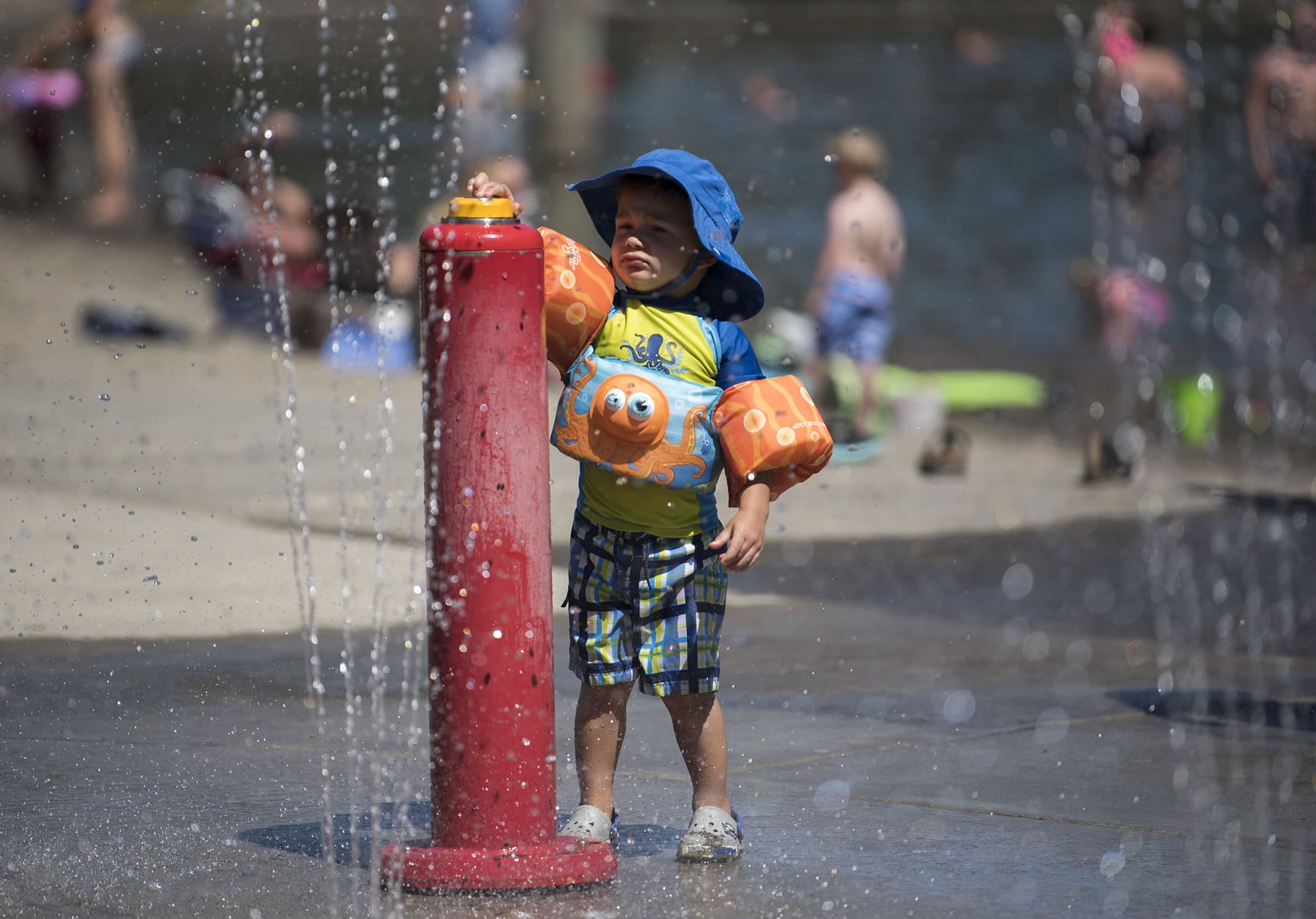 Carter Olsen of Vancouver, 2, plays in the water features at Klineline Pond on Monday afternoon July 31, 2017, in Salmon Creek. A heat wave is moving through the area this week with triple-digits forecasted for Wednesday and Thursday.