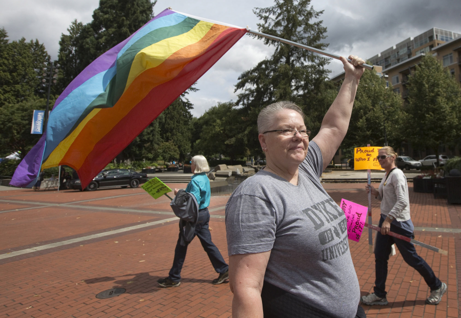 Eva Hoffman holds a rainbow flag at a Pride event at Esther Short Park in downtown Vancouver in 2016. The annual Vancouver USA Pride event celebrates the local LGBTQ community.