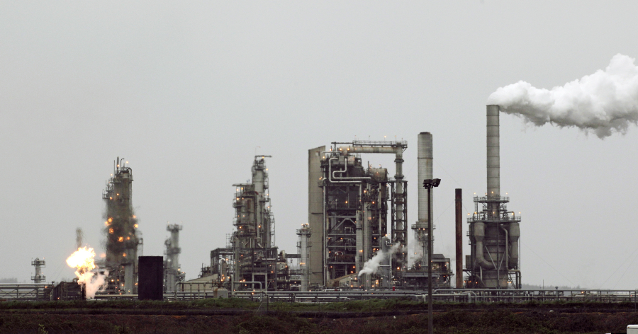 A Tesoro Corp. refinery, including a gas flare flame that is part normal plant operations, is shown in Anacortes.