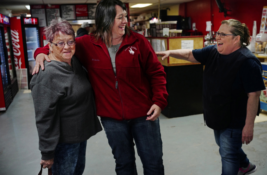 Judy Boepple, from left, her daughter and City Administrator Dawn Marquardt chat with Nana Lil’s Cafe owner Lillian Hoffman. Hoffman started the popular diner right before the oil boom took off.