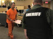 Kelly Brian Angell, 57, appears Friday in Clark County Superior Court to face charges of first-degree rape and first-degree kidnapping with sexual motivation stemming from an incident police began investigating in 2016.