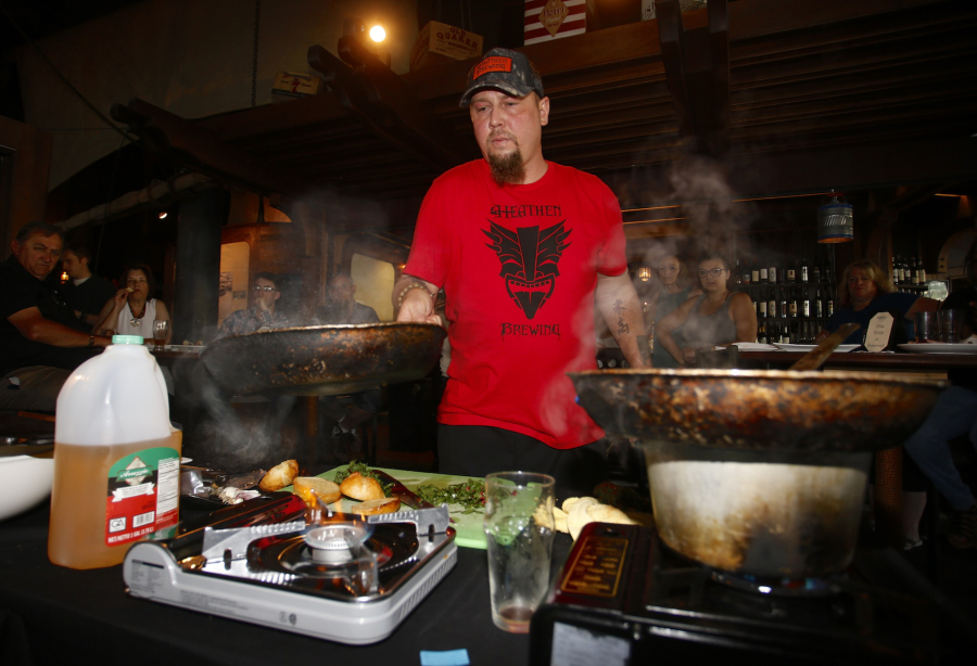 Michael Garofalo, executive chef at Heathen Brewing Feral Public House, competes at the Extreme Food Fights cooking competition at WareHouse ‘23.
