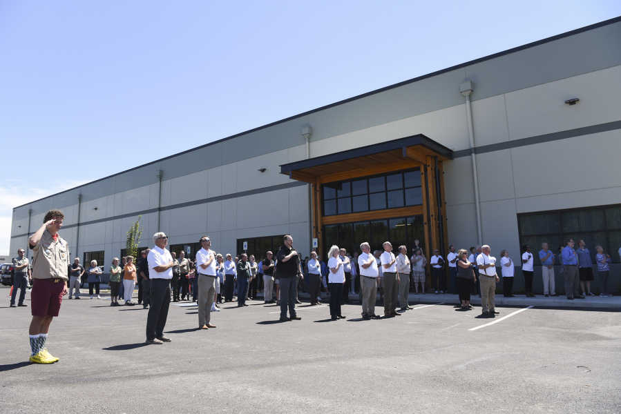 Employees from the Port of Ridgefield and state Fish and Wildlife’s Region 5 office join community members in the Pledge of Allegiance during a ceremony Wednesday for the opening of the new regional Fish and Wildlife headquarters in Ridgefield.