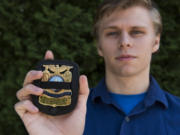 Union High School graduate Jake Cushman of Vancouver holds a replica of a badge that belonged to his father, Adam Cushman. When his father died in 2010, Jake Cushman and his brother were both given a replica of the badge that includes a black strap that commemorates fallen officers. Jake Cushman hopes to follow in his father’s footsteps by becoming a criminalist for the Portland Police Bureau.