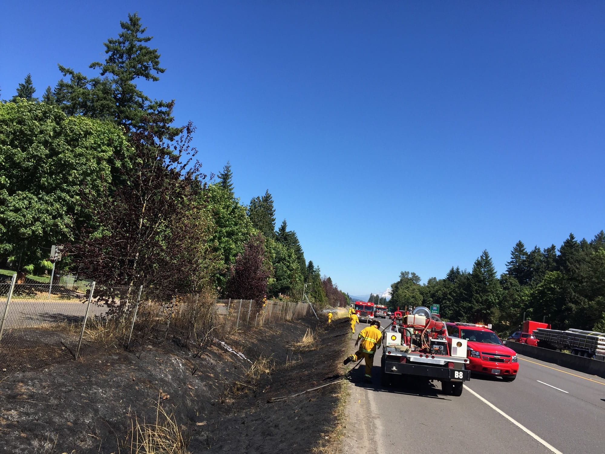 Firefighters respond to a grass fire, one of three, that burned along state Highway 14 Thursday afternoon.