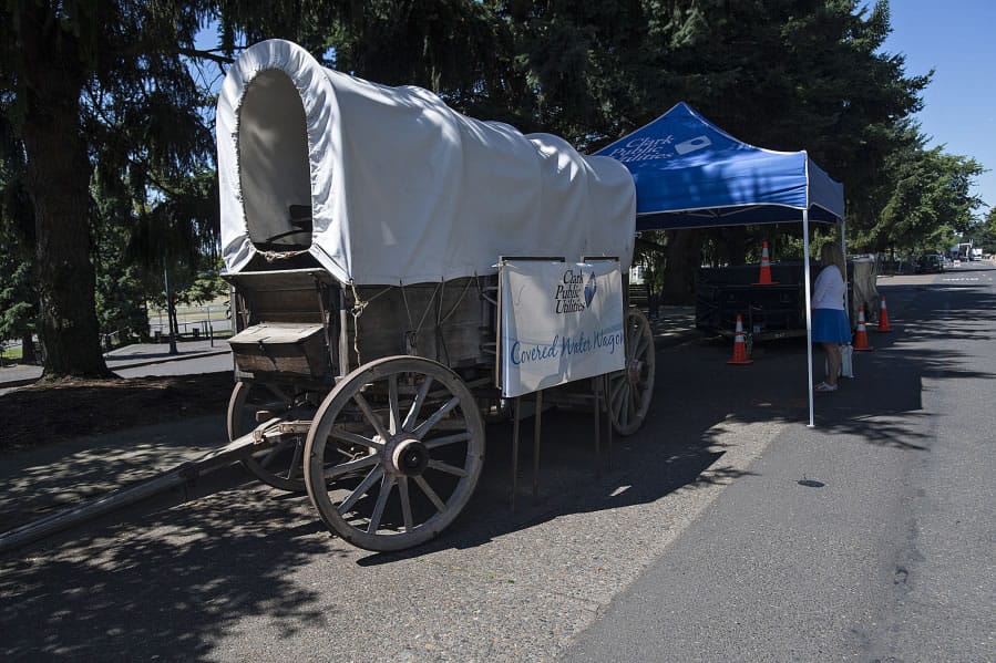 Clark Public Utilities workers get their water wagon ready Monday morning along East Fifth Street at Fort Vancouver National Historic Site.
