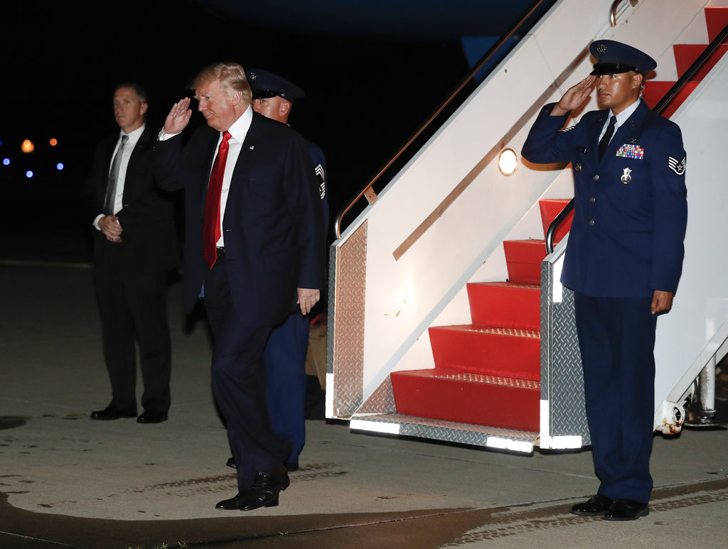 President Donald Trump salutes as he arrives on Air Force One at Morristown Municipal Airport, in Morristown, N.J., Saturday, July 1, 2017. Trump was en route to Trump National Golf Club in Bedminster, N.J., after attending an event at the Kennedy Center for the Performing Arts.