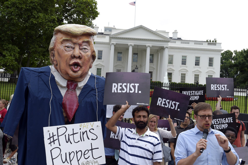 People gather outside the White House on Pennsylvania Avenue in Washington, Tuesday, July 11, 2017, to protest President Donald Trump.