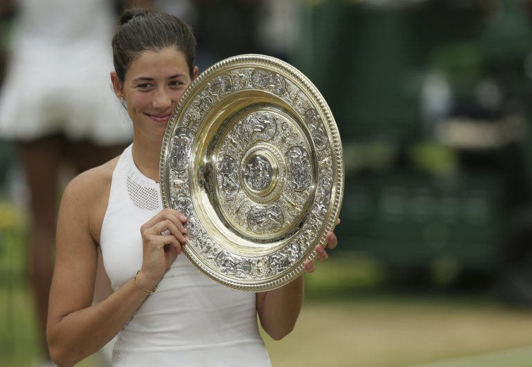 Spain's Garbine Muguruza holds up the trophy after defeating Venus Williams of the United States in the Women's Singles final match on day twelve at the Wimbledon Tennis Championships in London Saturday, July 15, 2017.