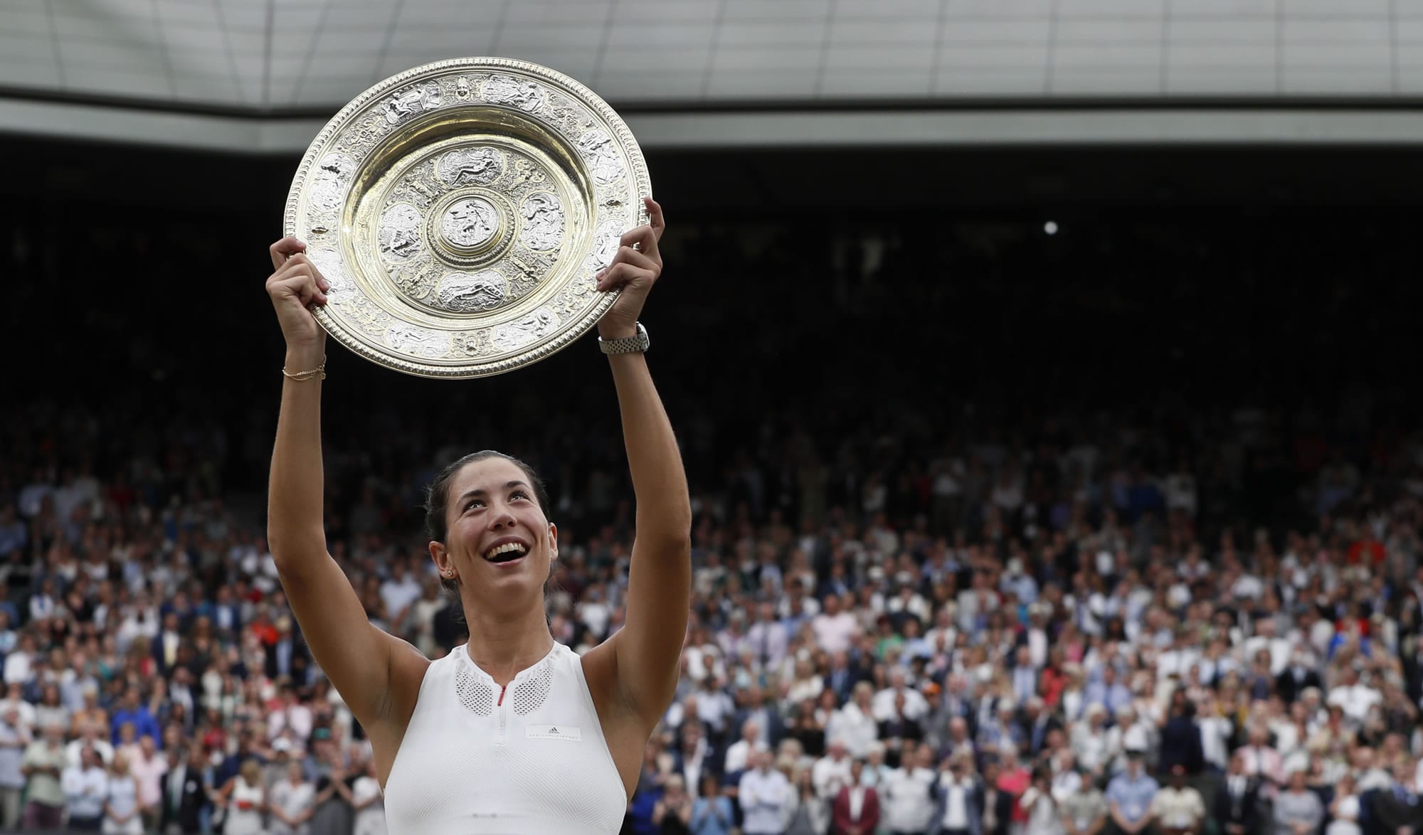 Spain's Garbine Muguruza holds the trophy after defeating Venus Williams of the United States in the Women's Singles final match on day twelve at the Wimbledon Tennis Championships in London Saturday, July 15, 2017.